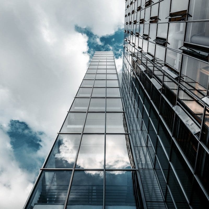 low angle photography of high rise building under cloudy sky